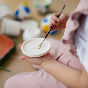 Happy kid at home DIY pot painting hobby